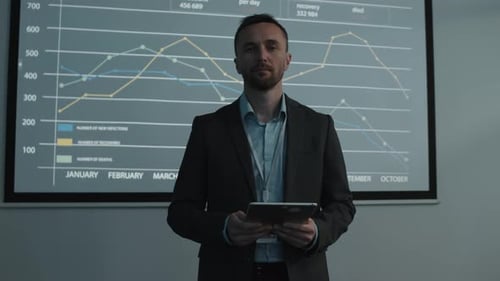 Man with Tablet Presenting Business Data