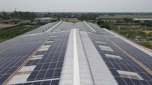 Aerial View Solar Panels on Factory Roof