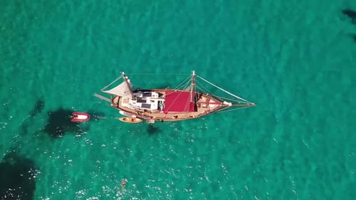 Sailboat Anchored in Turquoise Tropical Waters, Aerial View