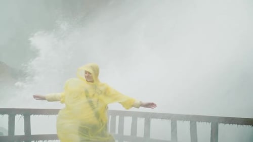 Woman Under the Streams of Niagara Falls Water Rejoices and Admires the Power of Nature Slow Motion