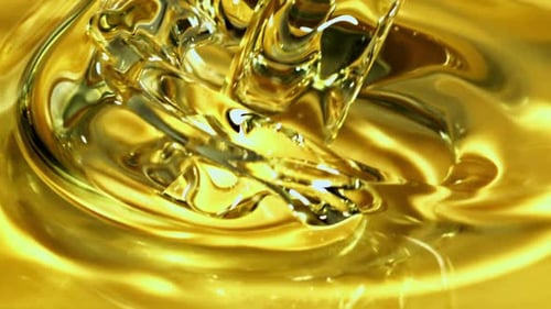 Golden Liquid Stream Pouring Close Up