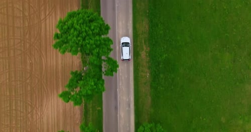 Aerial View Electric Car Driving on Country Road Luxury Modern Vehicle Riding Fast Along Trees and