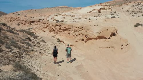 Aerial View of Couple Hiking Through Enchanted Ravine in Fuerteventura Desert
