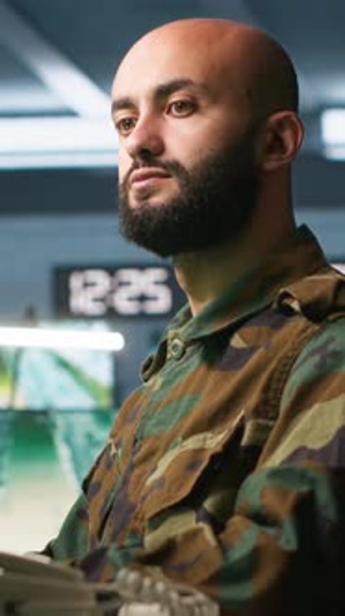 Vertical Video Officer Using Monitoring Equipment in Base of Operations on Enemy