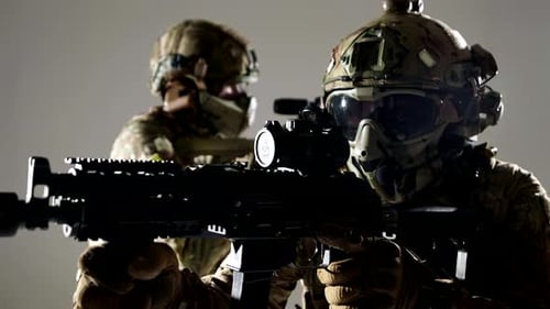 Soldiers in Camouflage Gear Aiming Weapons