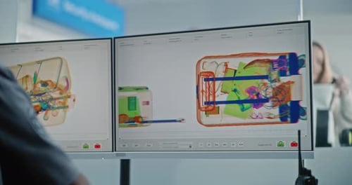 Airport Security Checkpoint Security Officer Checking Xray Scanning of Luggage on Computer
