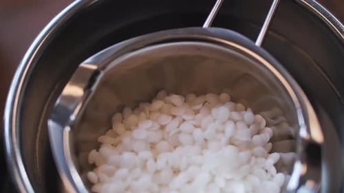 Close Up of White Pellets in Metal Container
