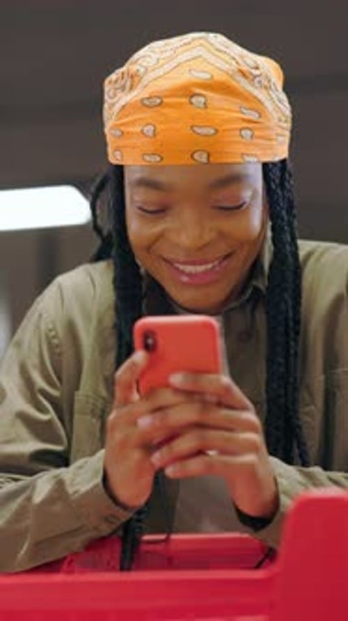 Young Woman Using Smartphone in Urban Store