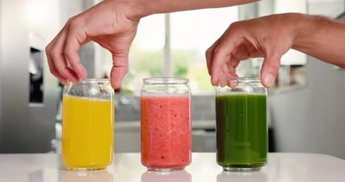 Health, juice and glass with hands in kitchen for detox, antioxidants and vegan drink