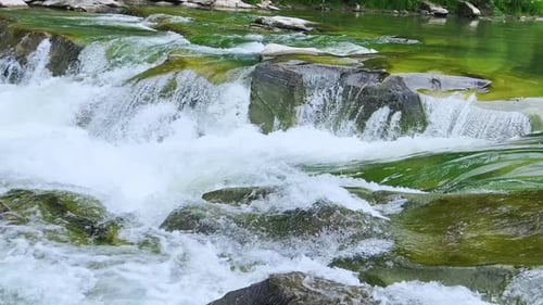 Stormy streams of water and cascades of mountain river waterfalls.