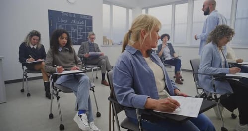 Adults Attending Class and Writing Notes in Classroom