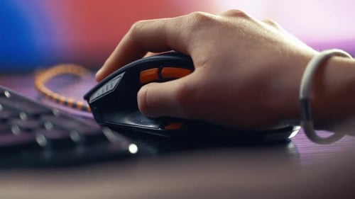 Hand Using Computer Mouse on a Desk