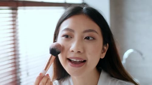 Young Woman Engages in a Home Spa Routine Featuring Skincare and Makeup