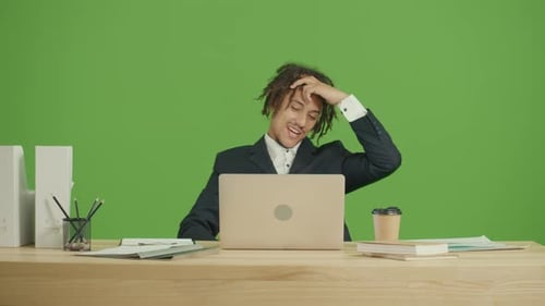 Young Adult Working on Laptop, Excited on Green Screen