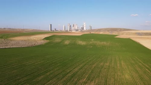 Aerial View of Green Field Near City