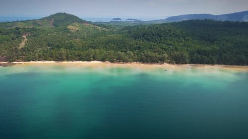 Drone View Of Beach Surrounded By Tropical Forest And Clear Blue Waters
