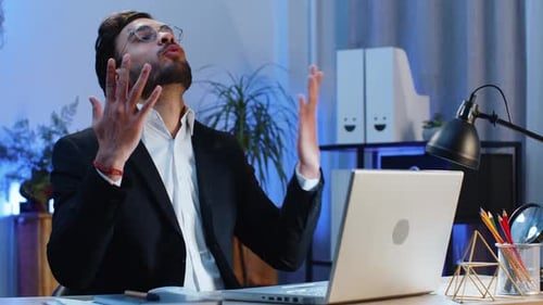 Adult in Blazer Using Laptop at Desk