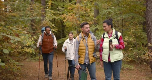 Group of Friends Hiking Together in Autumn Forest