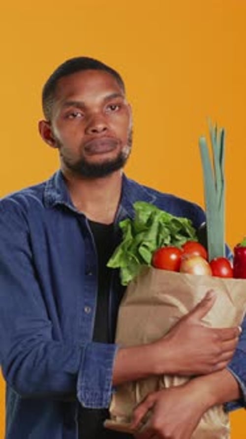 Adult Holding Bag Full of Fresh Vegetables