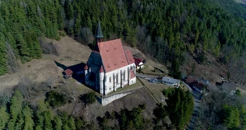 Orbiting Drone Shot of a Church on a Mountain near a Village, 4k UHD