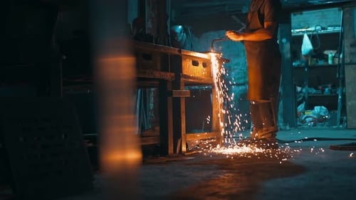 A Male Locksmith Cuts Metal with an Oxyfuel Torch in a Metal Cutting Workshop