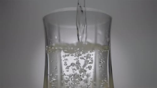 Air Bubbles Rise in the Glass As Water is Poured