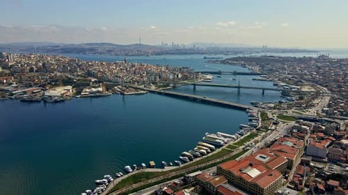 A Istanbul city with a bridge over a river and boats on the water