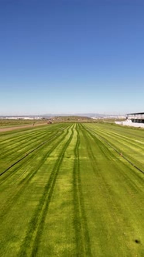 Aerial Drone View of Turf Harvesting Machine Working on Field