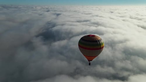 Hot Air Balloon Flying Above Clouds