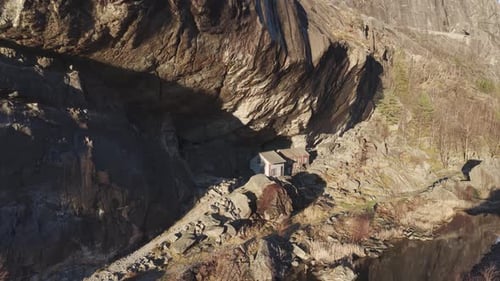 Two old historical houses under a cliff in Southern Norway. Drone footage