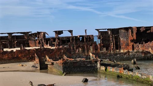 Close-up of the Rusty Hull of an Old Shipwreck on the Beach