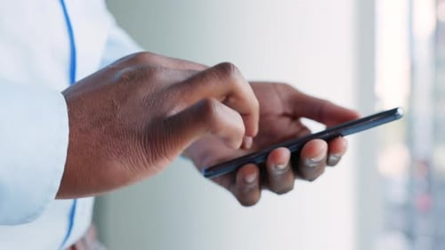 Chatting, texting or typing hands of a business man on a phone in a modern office