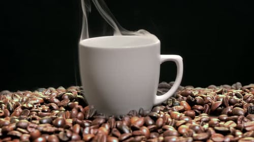 Steaming Mug of Coffee with Roasted Beans