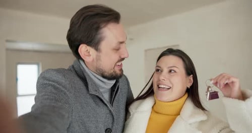 Happy Couple Shows Keys To New Home