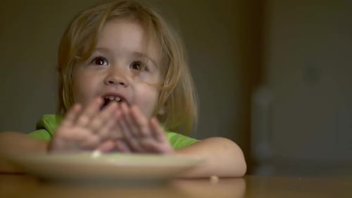 Happy Blond Child Smiling and Waving Indoors