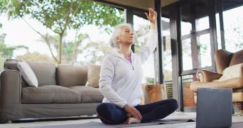 Senior Woman Practicing Yoga in Living Room