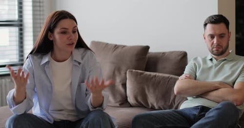 Couple Arguing on Sofa in Home Interior