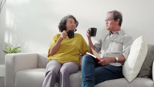 Senior Couple Reading and Enjoying Coffee Together