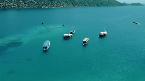 Leisure Boats Floating in Calm Turquoise Bay beside Curved Green Hills near Kekova