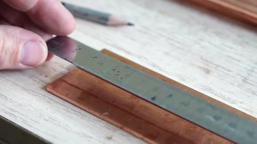 Hands of Engineer Prepare Copper Bars for Drill