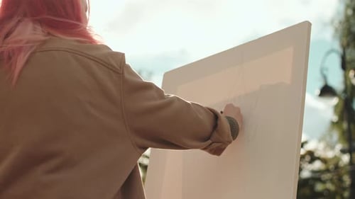 Female Artist Drawing on Canvas in Park