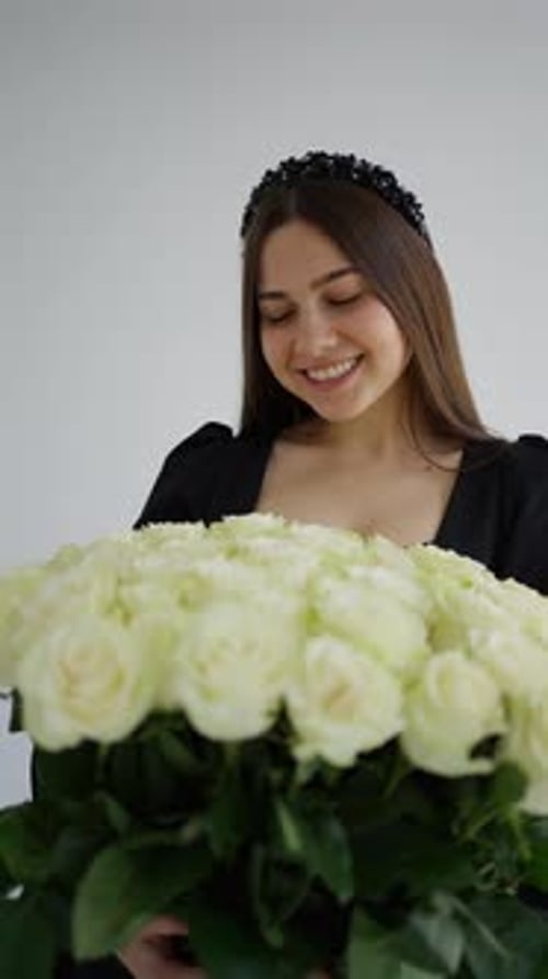 Woman Smiling with Bouquet of White Roses