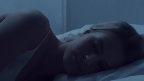 Woman Sleeping Peacefully in Bed at Night