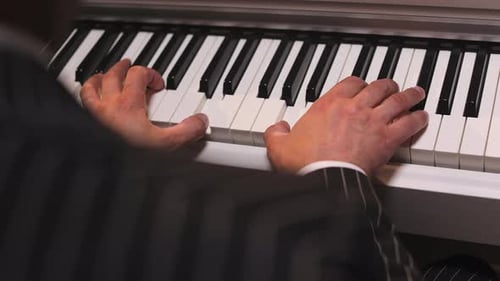 Man Playing Piano in a Close Up View