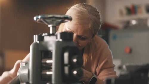 Jeweler Flattening Metal Wire Using a Rolling Mill Machine