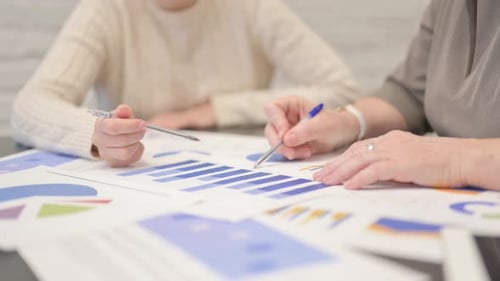 Team Analyzing Business Data and Charts Together