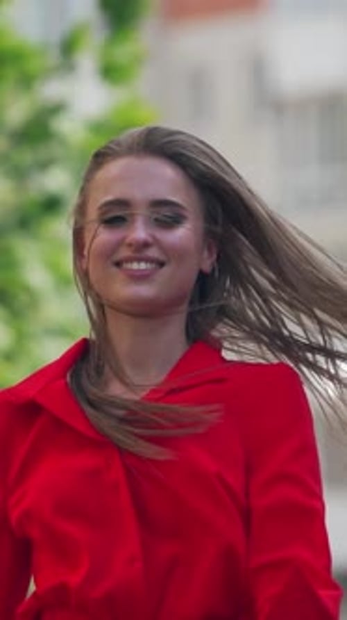 Woman walking in the street. Young beautiful woman smilling and walking in the town. Vertical video