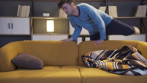 Young Man Sleeping on a Cozy Couch Indoors