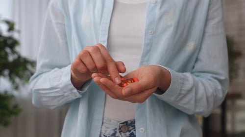 Close Up of Person Holding Pills