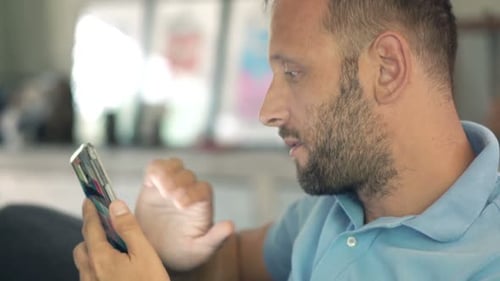 Man Using Mobile Phone in Living Room